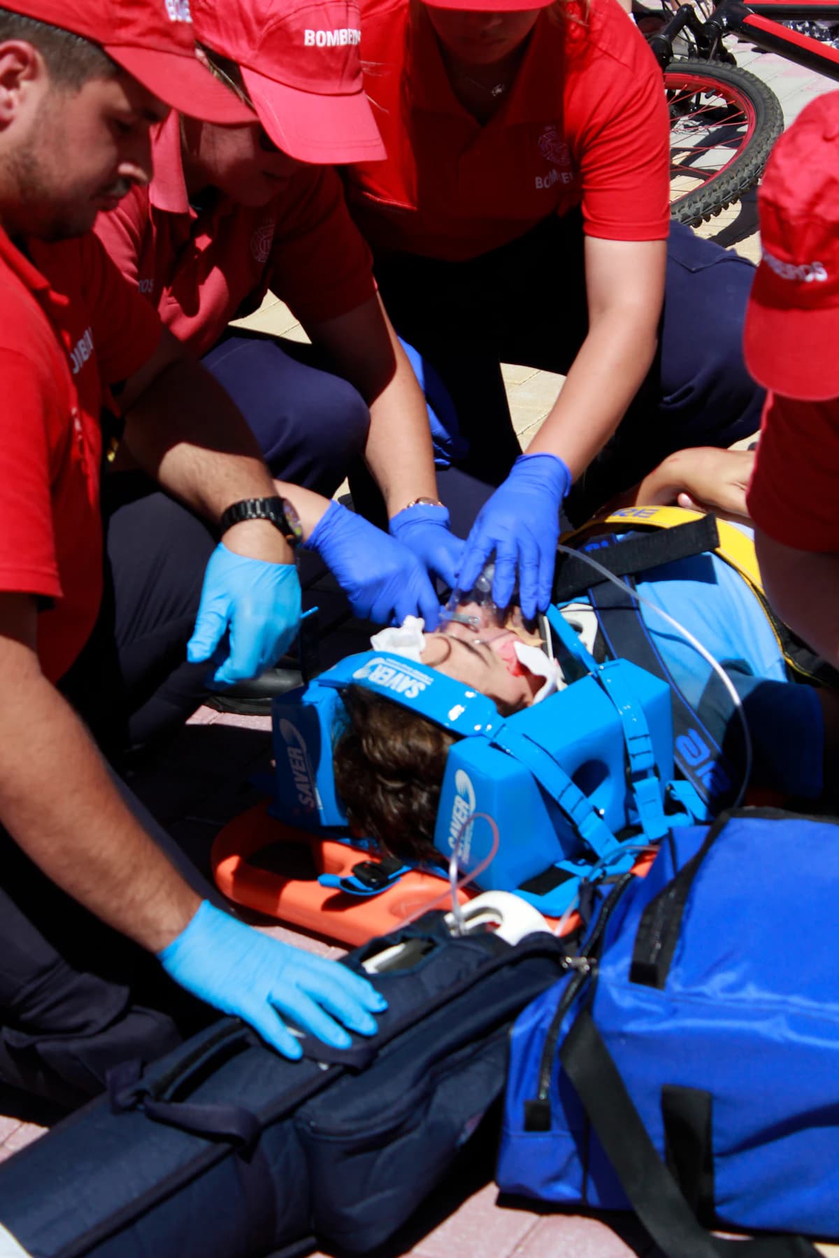 Group of people performing first aid practice on training mannequins during an indoor class