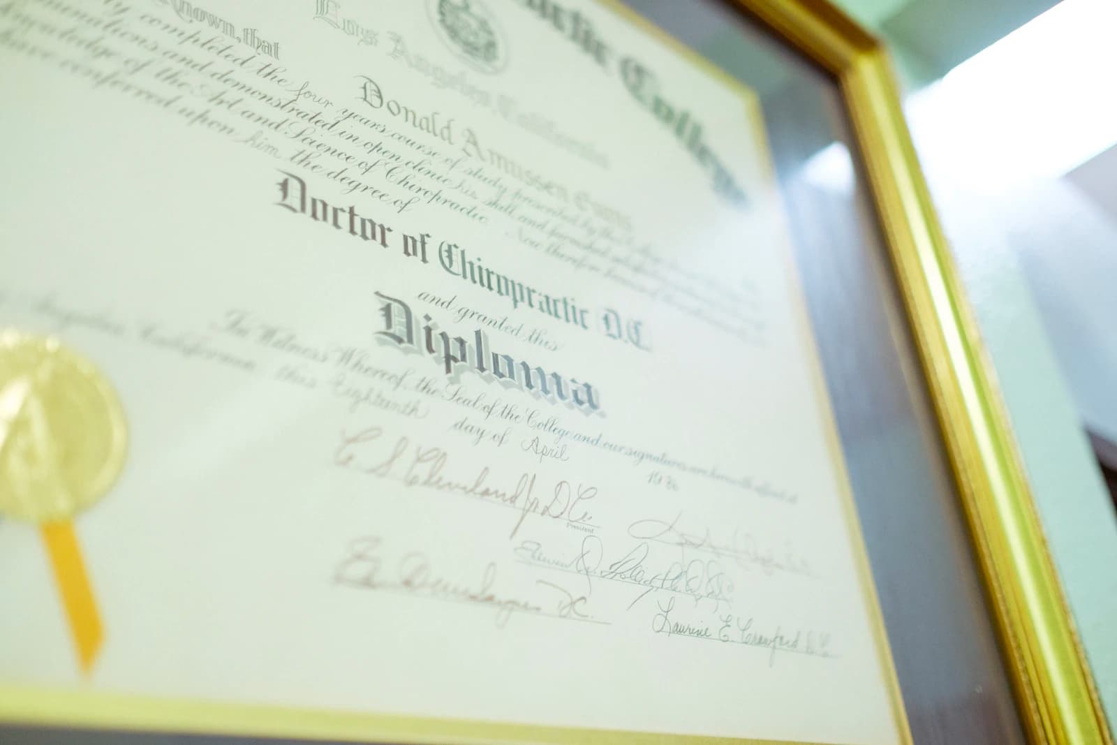 Framed diploma or certificate with a gold seal representing achievement